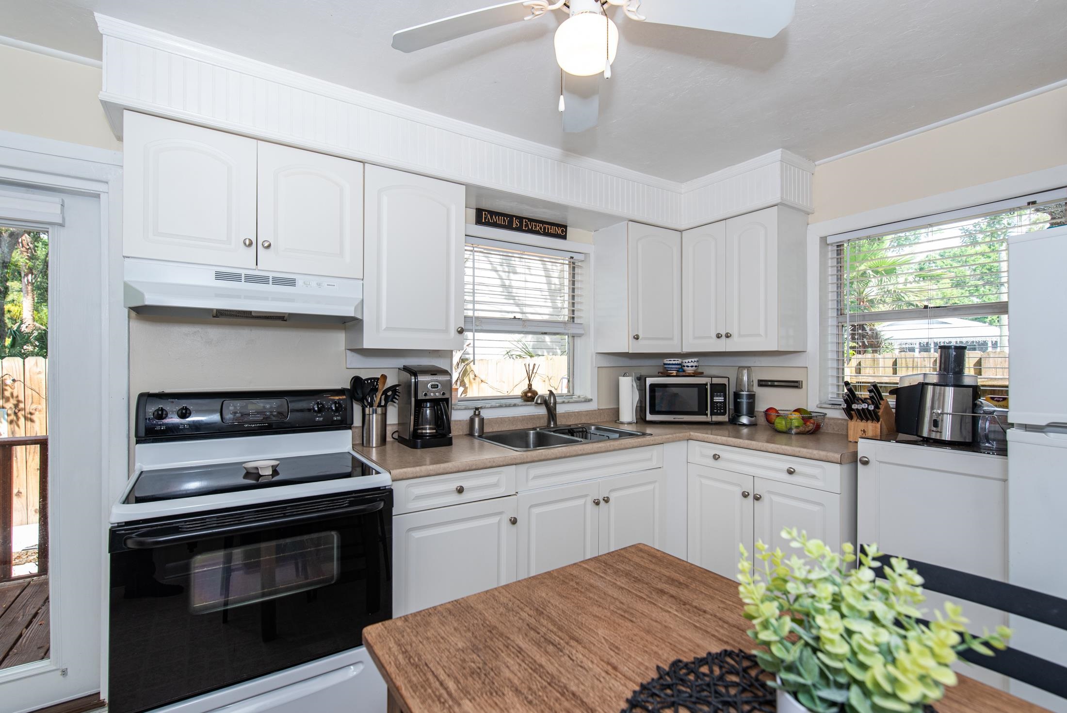 132 Oneida Street St. Augustine, FL 32084 - Photo 20 of 36 a kitchen with stainless steel appliances a stove sink and cabinets