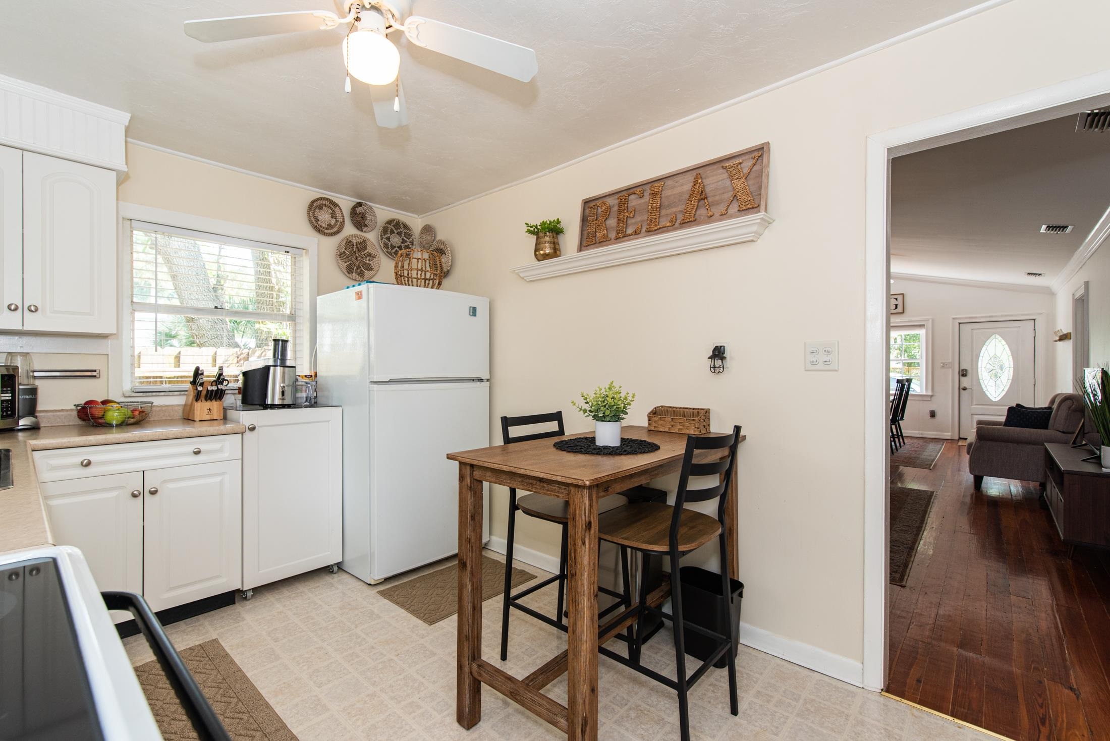 132 Oneida Street St. Augustine, FL 32084 - Photo 21 of 36 a kitchen with stainless steel appliances granite countertop a dining table chairs refrigerator and sink