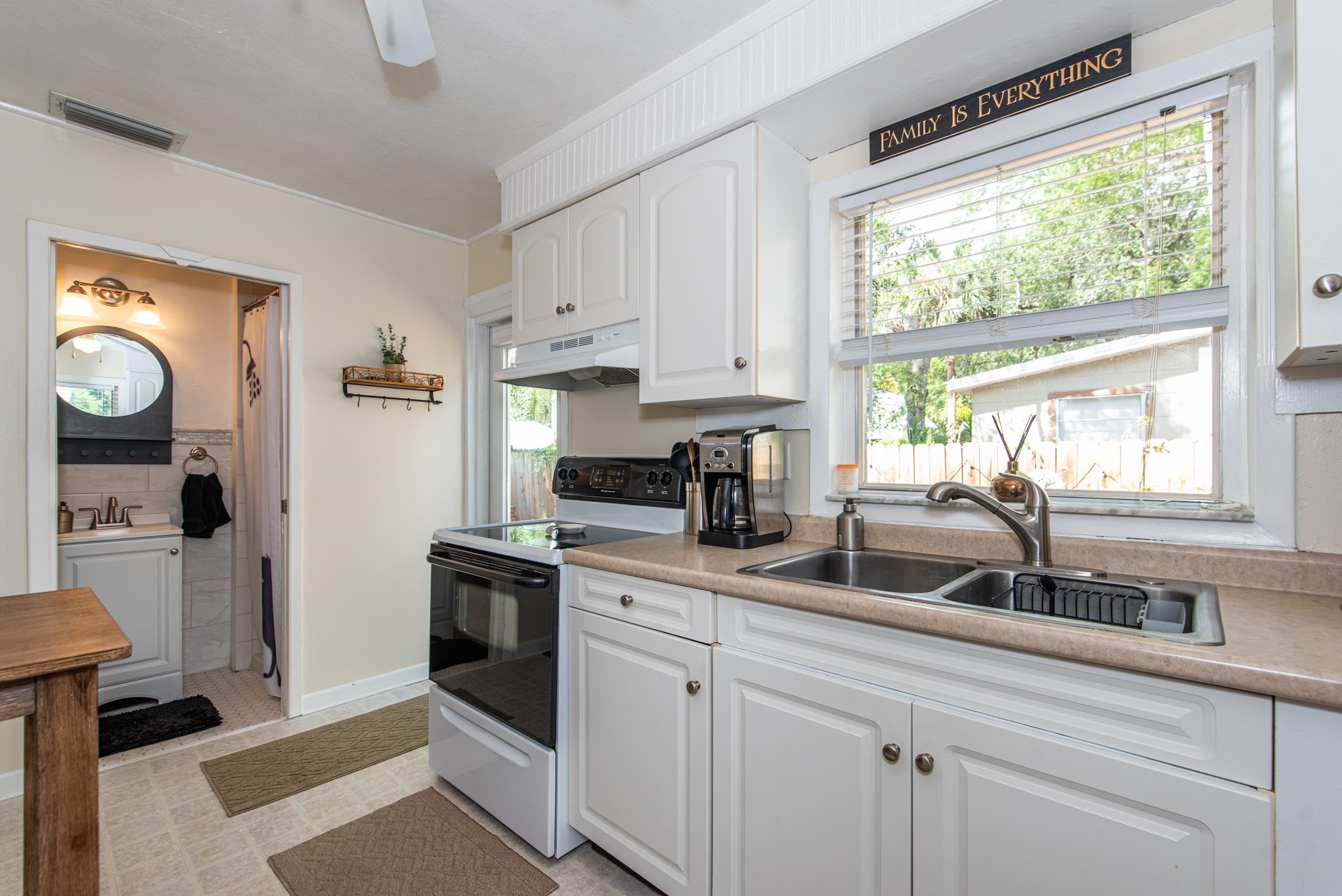 132 Oneida Street St. Augustine, FL 32084 - Photo 22 of 36 a kitchen with a sink cabinets and window