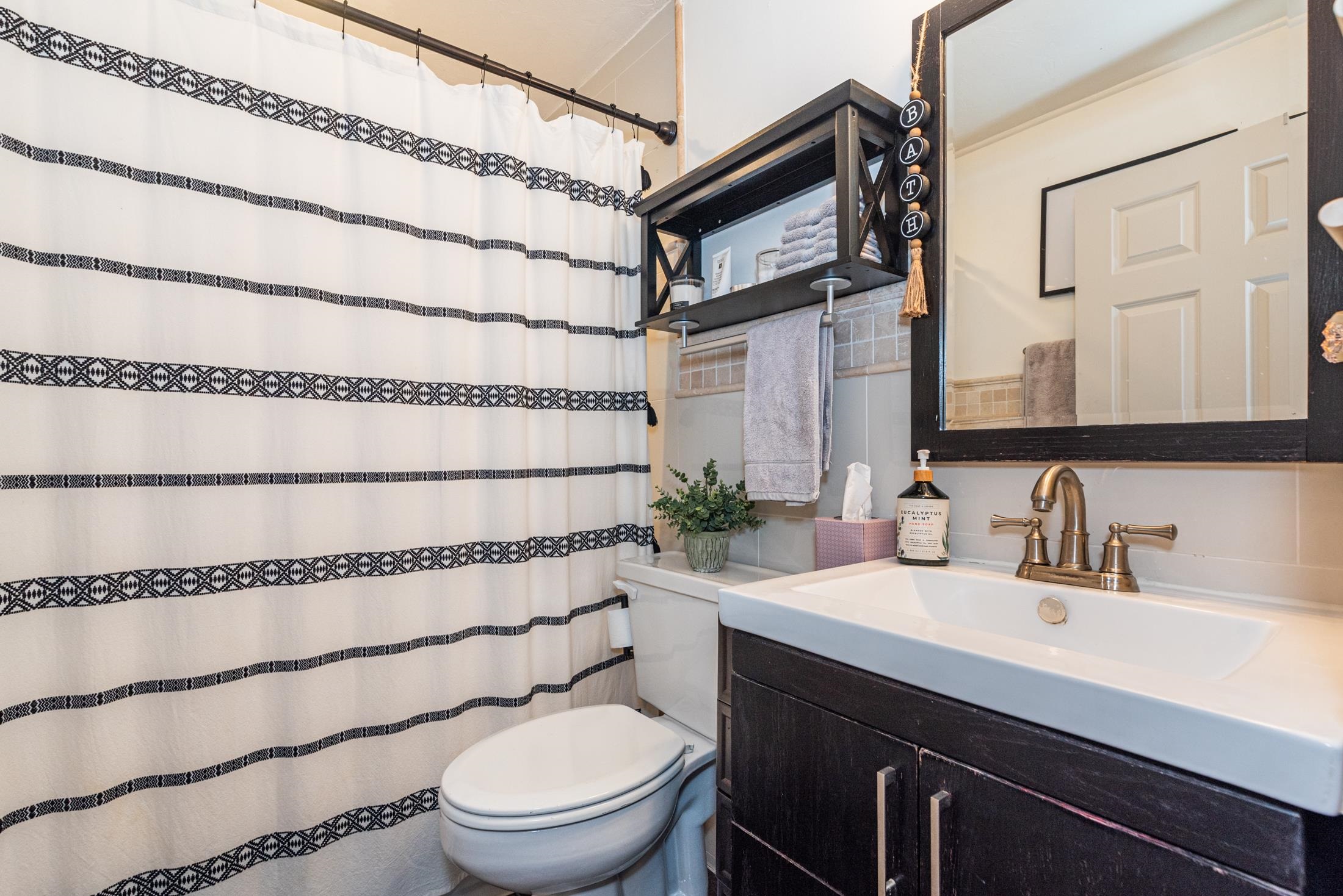 132 Oneida Street St. Augustine, FL 32084 - Photo 27 of 36 a bathroom with a sink a toilet and shower curtain