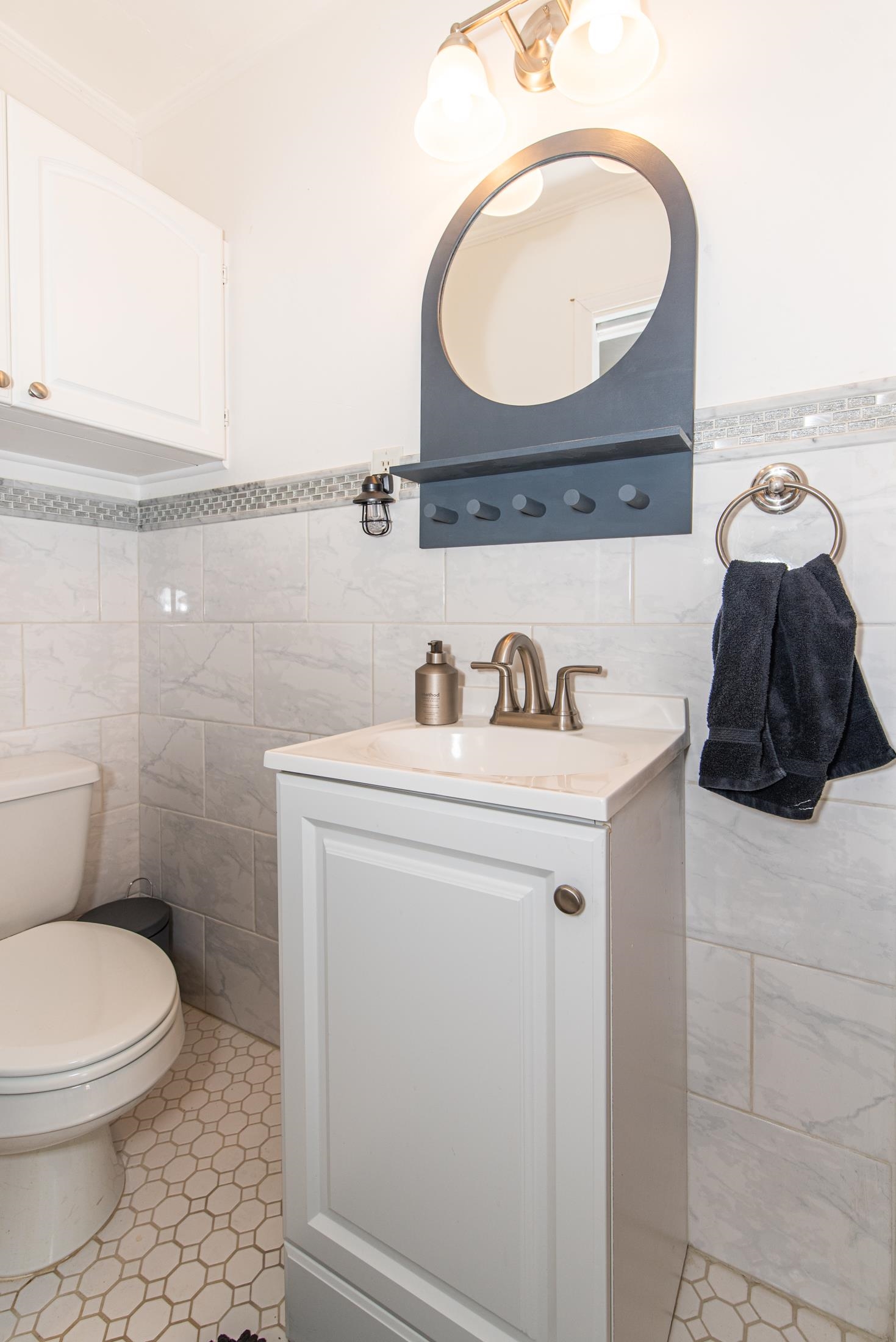 132 Oneida Street St. Augustine, FL 32084 - Photo 29 of 36 a bathroom with a sink a toilet and a mirror