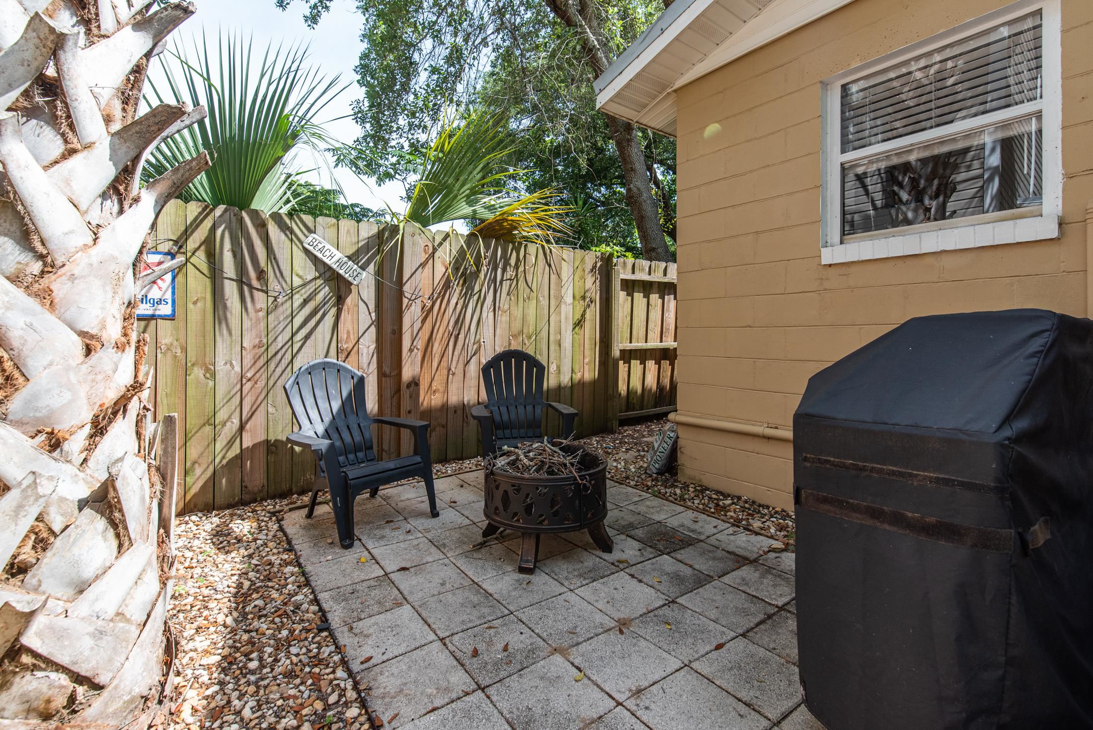 132 Oneida Street St. Augustine, FL 32084 - Photo 30 of 36 a backyard of a house with barbeque oven table and chairs