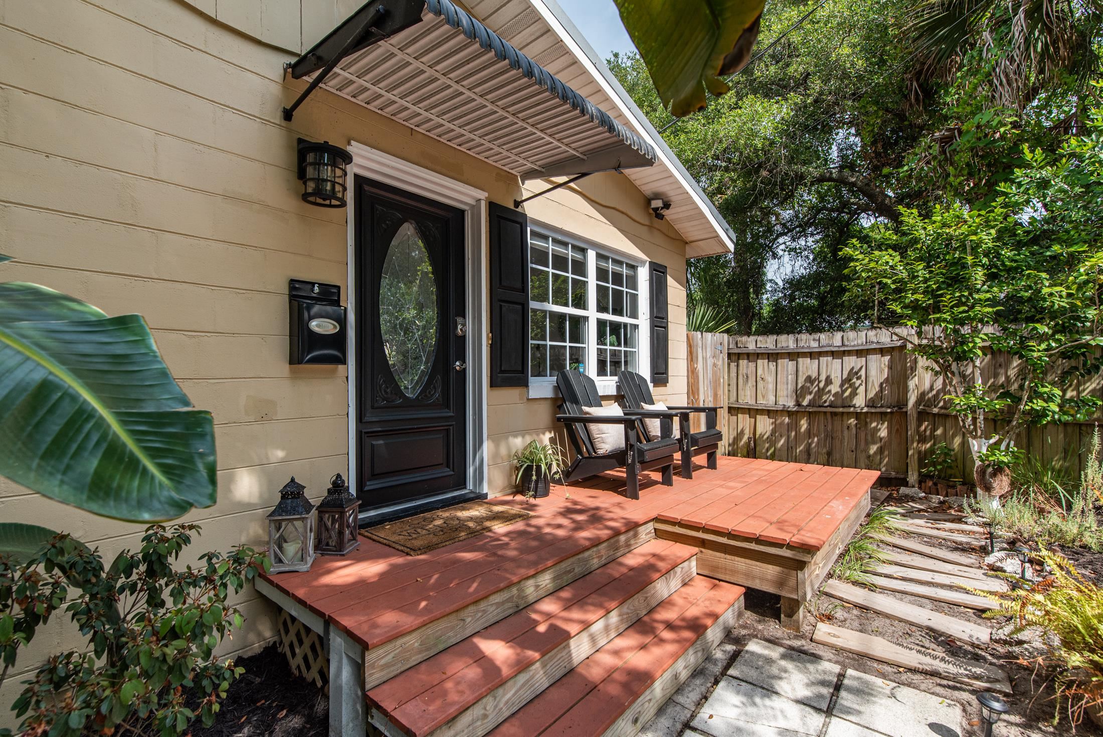 132 Oneida Street St. Augustine, FL 32084 - Photo 34 of 36 a view of a patio with table and chairs with wooden floor and fence