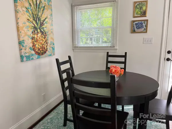 a view of a dining room with furniture and window
