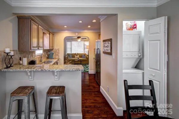 a kitchen with stainless steel appliances granite countertop a refrigerator and a sink