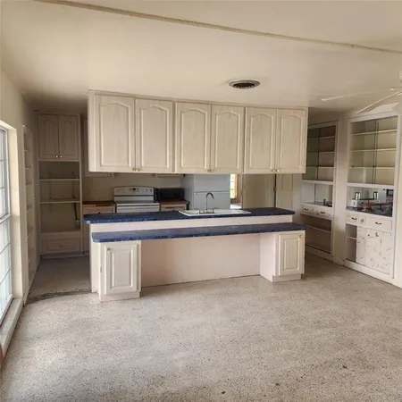 a kitchen with stainless steel appliances a stove a sink and a refrigerator