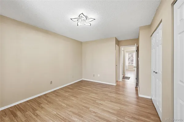 a view of an empty room with wooden floor