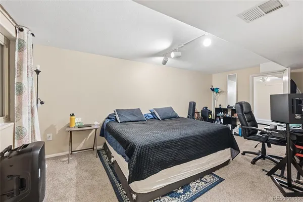 a bedroom with a bed and a desk