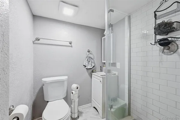 a bathroom with a toilet and a shower