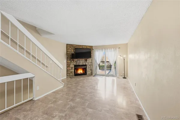 a view of an empty room with a fireplace