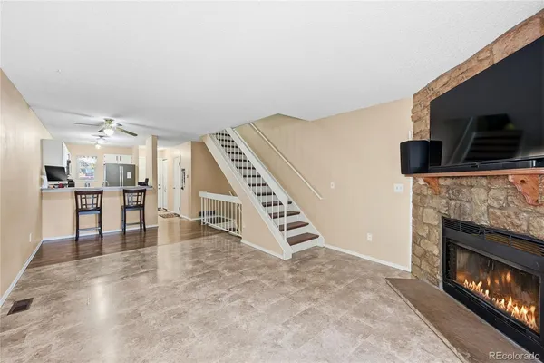 a view of an empty room with furniture wooden floor and fireplace