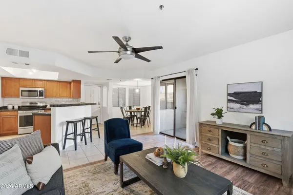 a living room with furniture a window and kitchen view
