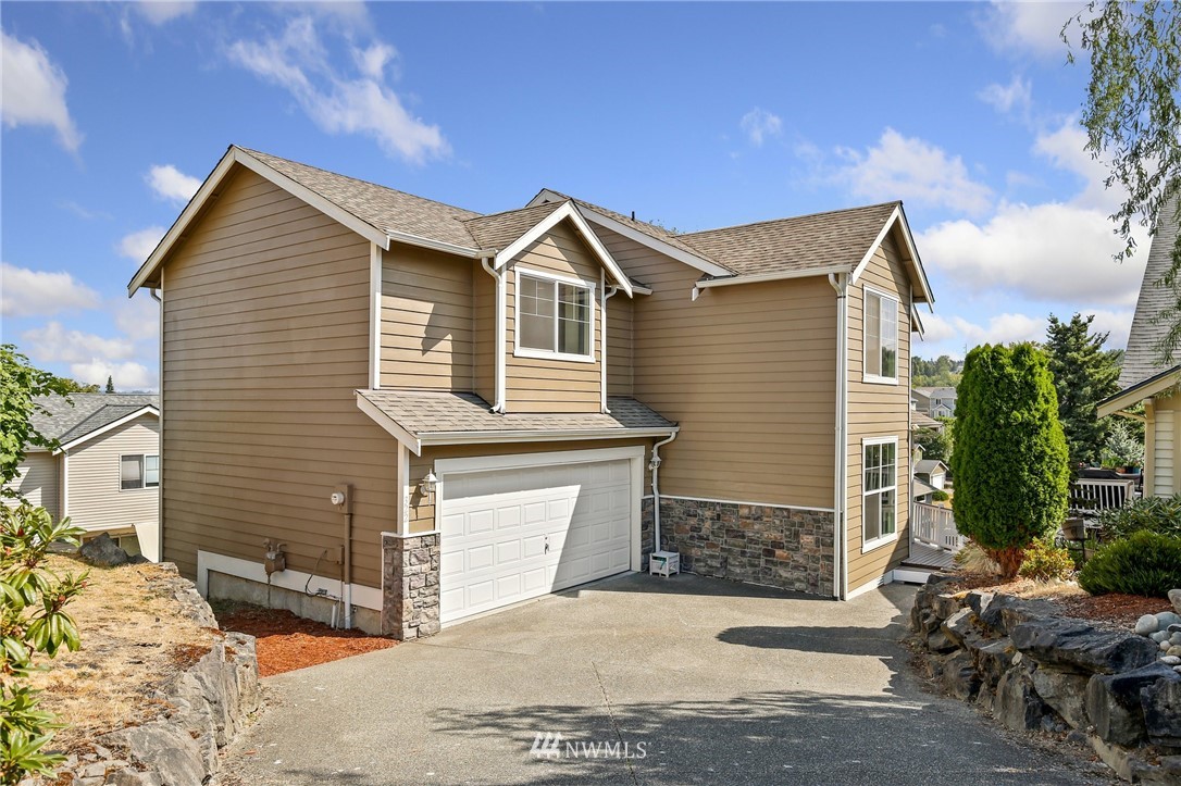 322 South 21st Street Renton, WA 98055 - Photo 1 of 29 a front view of a house with a yard and garage
