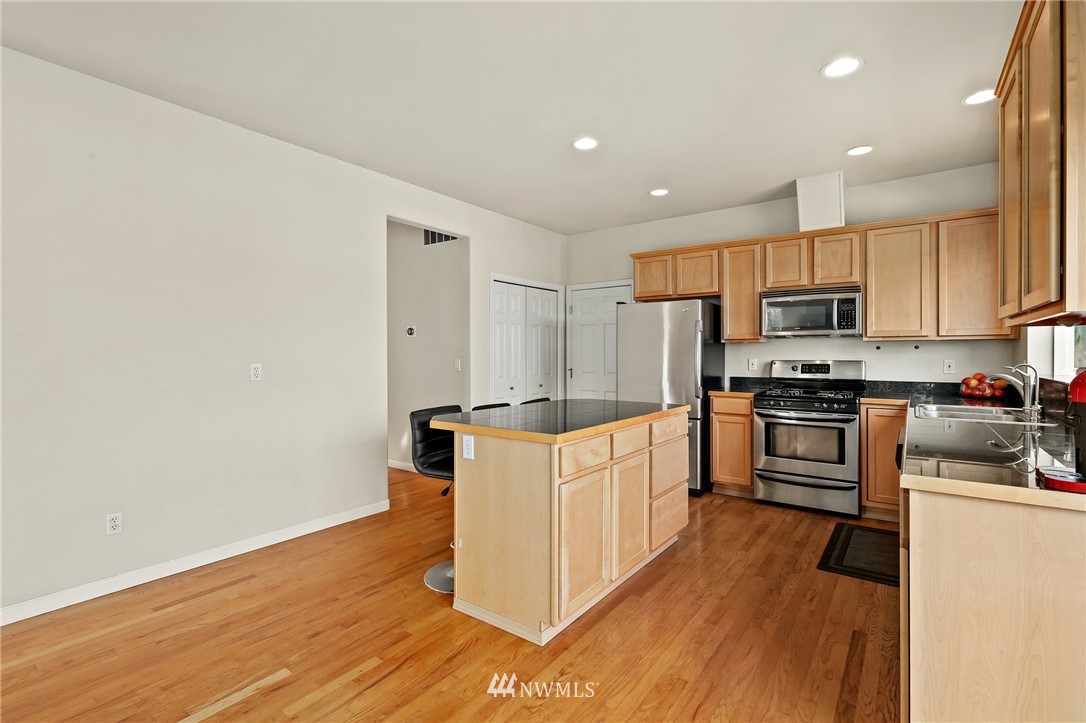 322 South 21st Street Renton, WA 98055 - Photo 7 of 29 a kitchen with granite countertop a stove top oven and cabinets