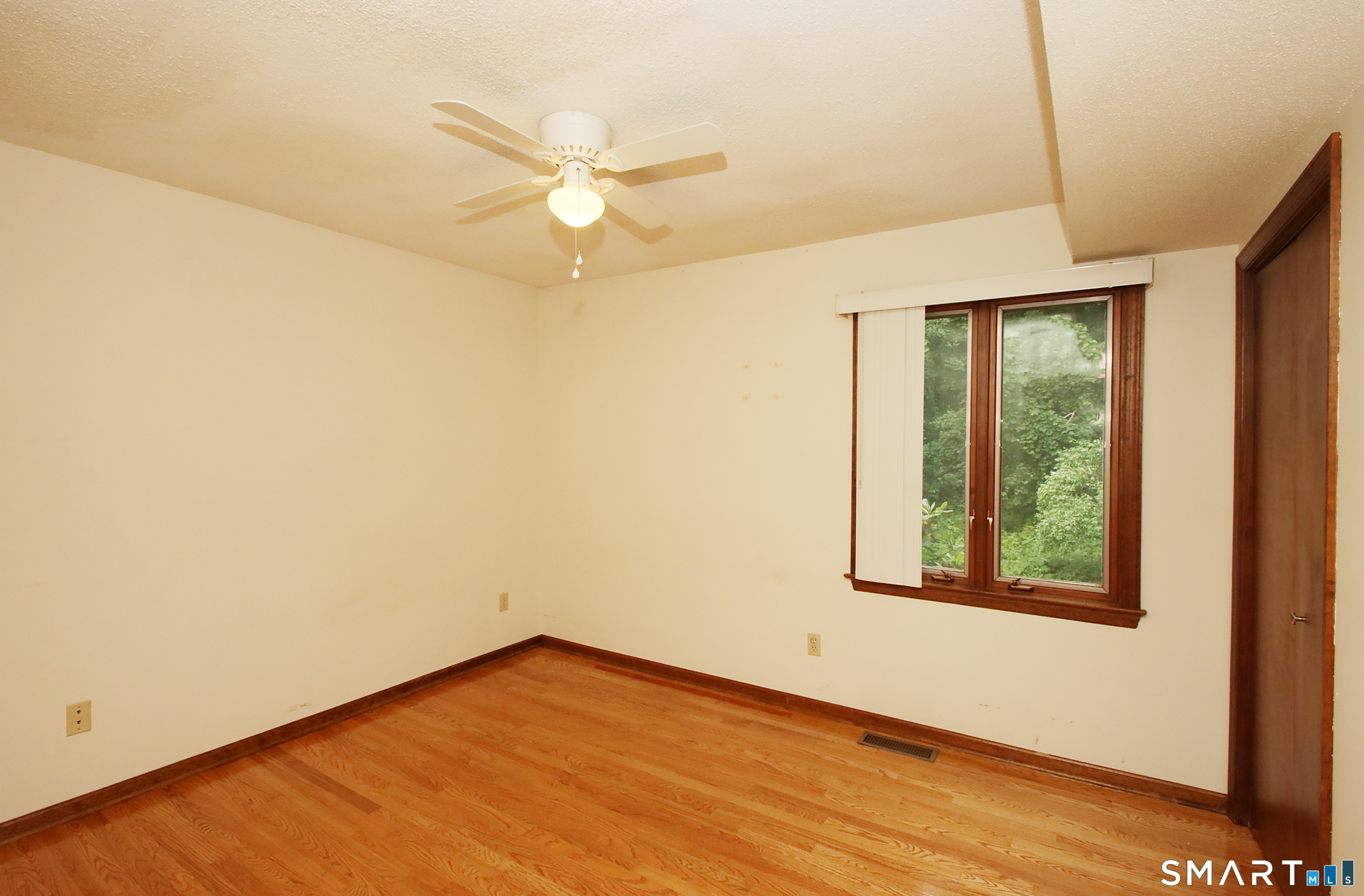 352 Center Street Wolcott, CT 06716 - Photo 26 of 40 an empty room with wooden floor fan and windows