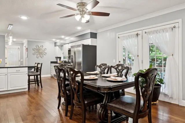 a view of dining table chairs and wooden floor