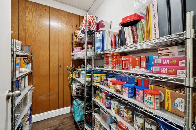 a bedroom with a bed dresser and a window