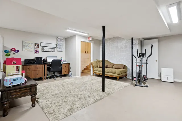 an aerial view of residential house with outdoor space and trees all around