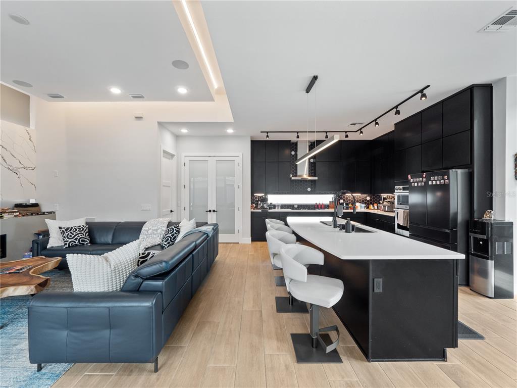 239 Hampton Loop Davenport, FL 33837 - Photo 14 of 43 a living room with furniture and kitchen view