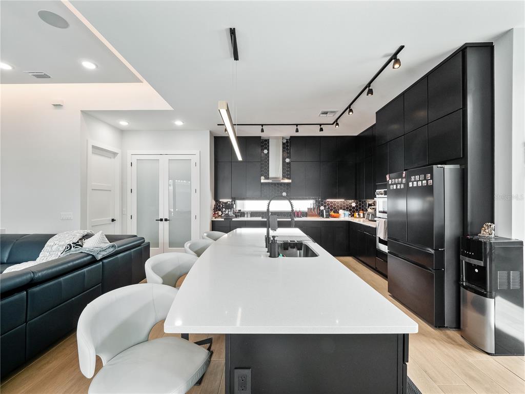 239 Hampton Loop Davenport, FL 33837 - Photo 15 of 43 a kitchen with a table chairs refrigerator and microwave