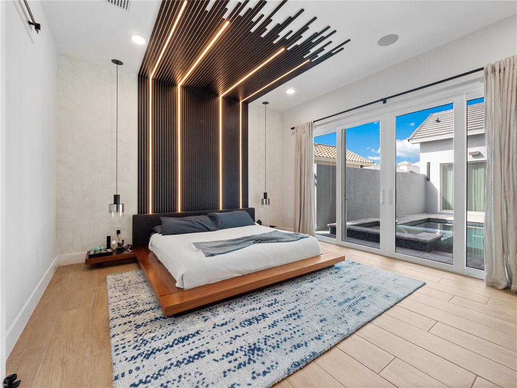 239 Hampton Loop Davenport, FL 33837 - Photo 23 of 43 a spacious bedroom with a bed and a large mirror