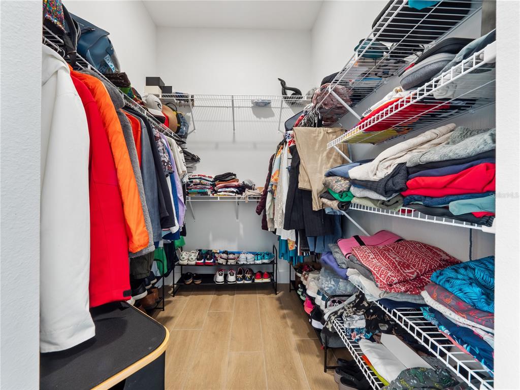 239 Hampton Loop Davenport, FL 33837 - Photo 24 of 43 a view of walk in closet with clothes and shoes