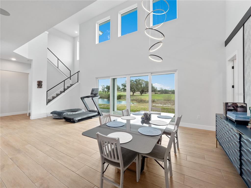 239 Hampton Loop Davenport, FL 33837 - Photo 28 of 43 a view of a dining room with furniture window and wooden floor