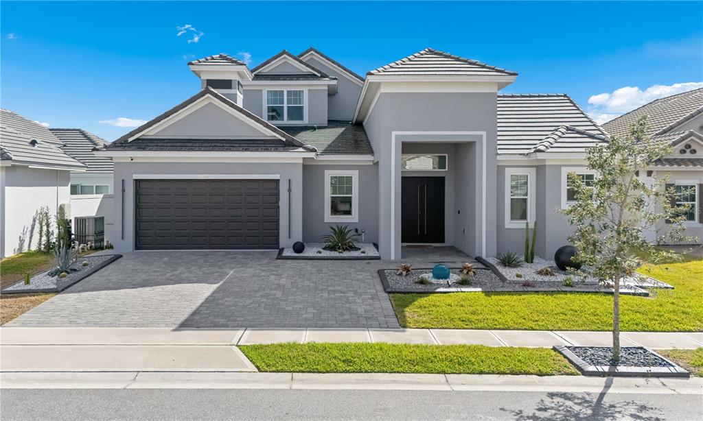 239 Hampton Loop Davenport, FL 33837 - Photo 3 of 43 a front view of a house with garden