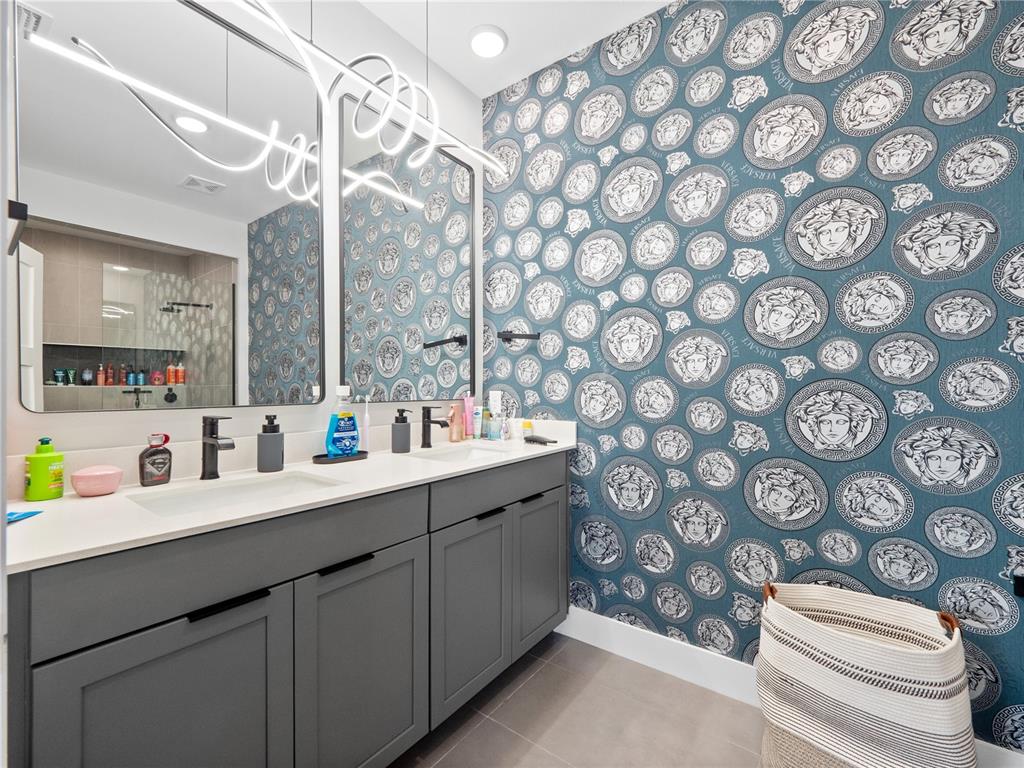 239 Hampton Loop Davenport, FL 33837 - Photo 34 of 43 a bathroom with a double vanity sink mirror and toilet