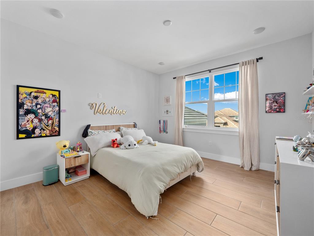 239 Hampton Loop Davenport, FL 33837 - Photo 35 of 43 a bedroom with a bed and a window