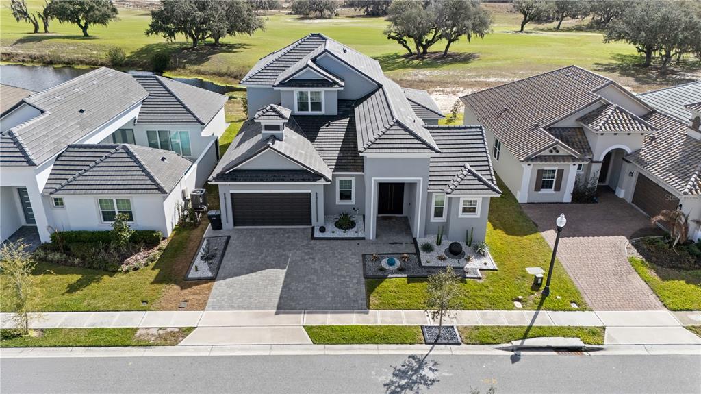239 Hampton Loop Davenport, FL 33837 - Photo 40 of 43 a front view of a house with garden