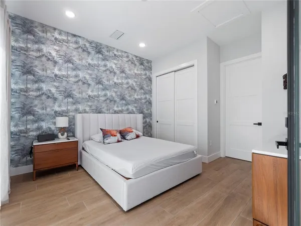 a bedroom with a bed and a couch