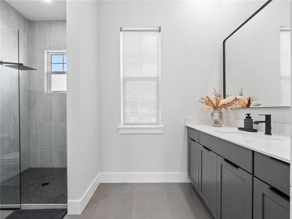 239 Hampton Loop Davenport, FL 33837 - Photo 9 of 43 a bathroom with a sink and a mirror