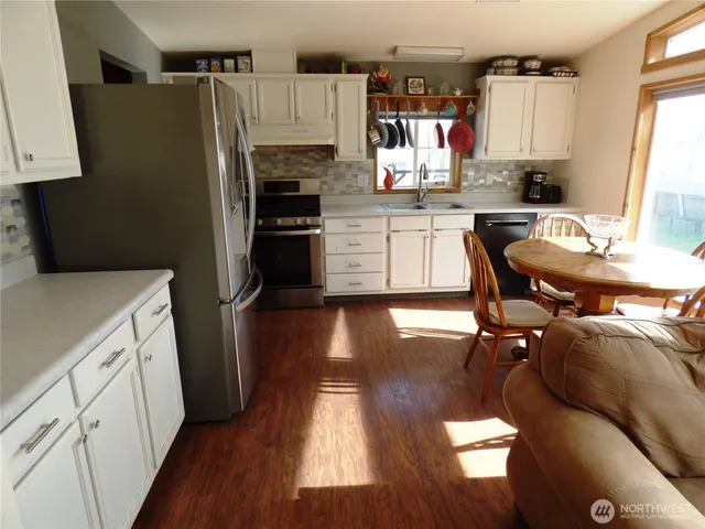 a kitchen with a sink appliances and cabinets