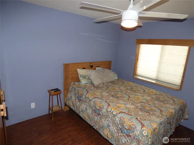 a bed sitting in a bedroom next to a window