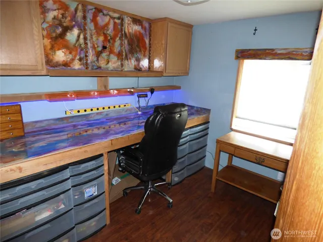 a view of a room with wooden floor and chair
