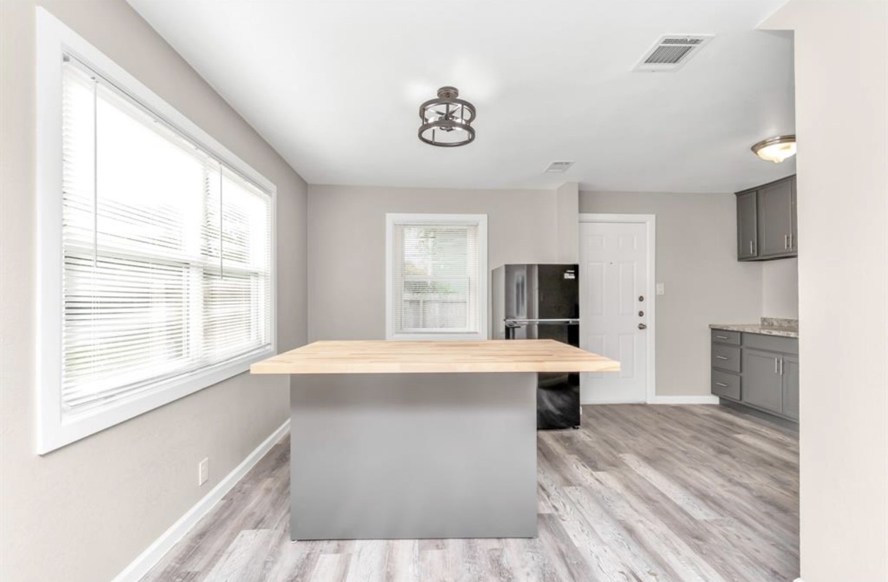 3404 Blodgett Street Houston, TX 77004 - Photo 12 of 19 a view of kitchen with stainless steel appliances wooden floor and large window