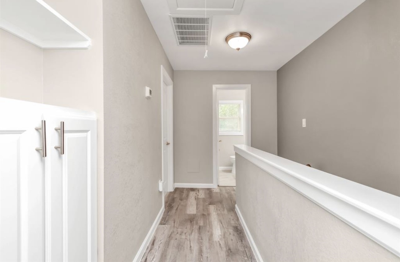 3404 Blodgett Street Houston, TX 77004 - Photo 2 of 19 a view of a hallway with wooden floor and staircase