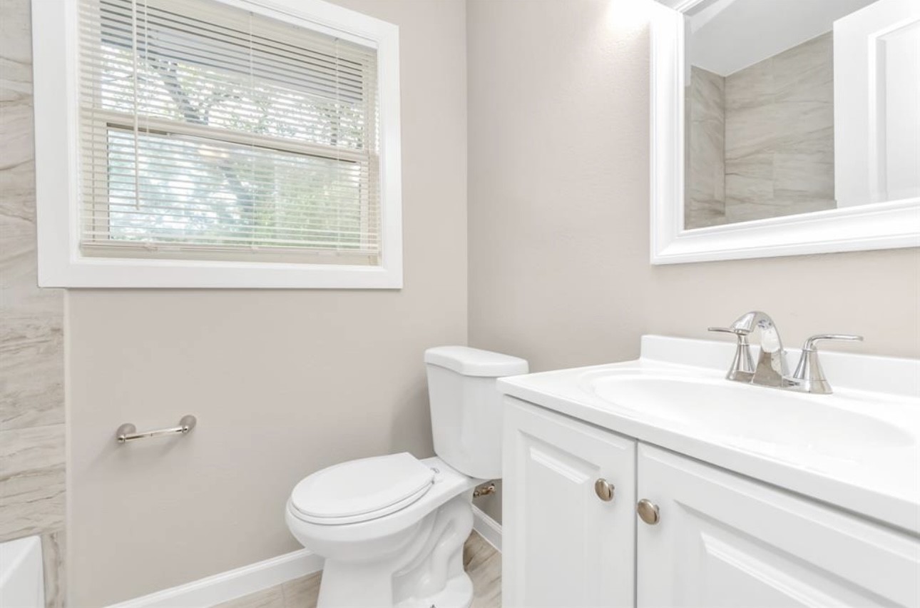 3404 Blodgett Street Houston, TX 77004 - Photo 5 of 19 a bathroom with a sink toilet and window
