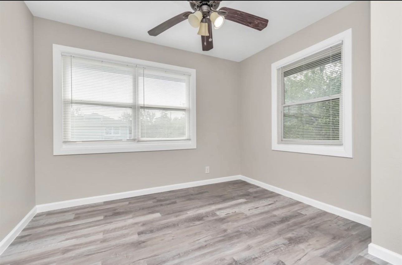 3404 Blodgett Street Houston, TX 77004 - Photo 6 of 19 a view of an empty room with a window and wooden floor