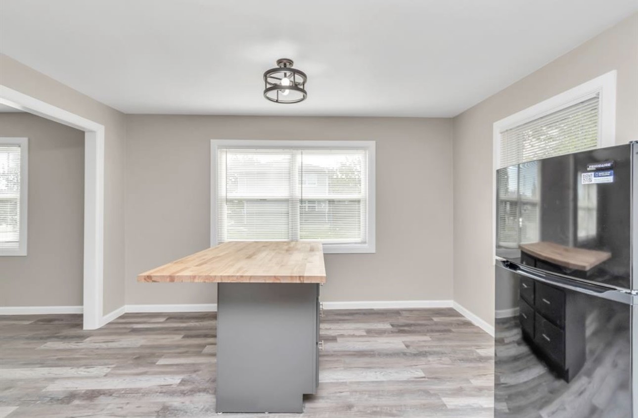 3404 Blodgett Street Houston, TX 77004 - Photo 9 of 19 a room with granite countertop a stove and a wooden floor