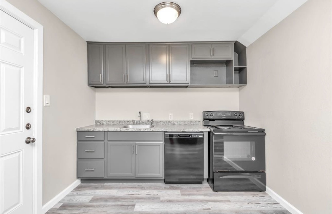3404 Blodgett Street Houston, TX 77004 - Photo 10 of 19 a kitchen with stainless steel appliances granite countertop a stove a sink and a microwave