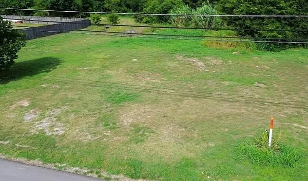 a view of a golf course with a wooden fence