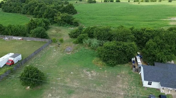 a backyard of a house with lots of green space and lake view