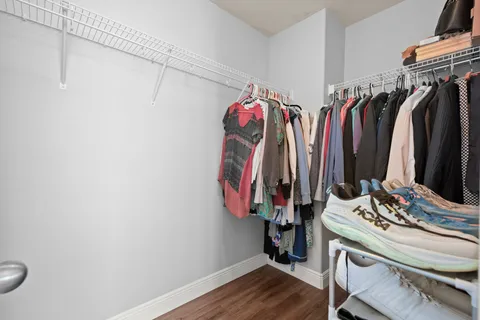 a view of walk in closet with clothes