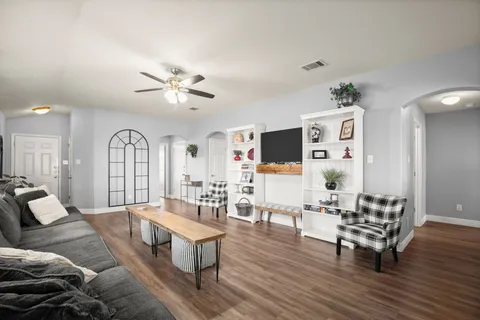 a living room with furniture and wooden floor