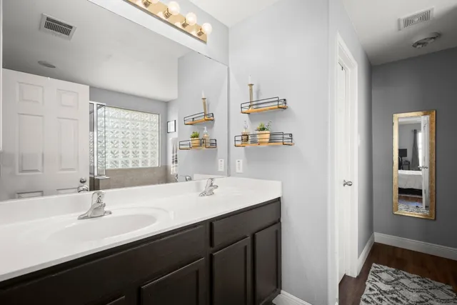 a bathroom with a sink double vanity and a mirror