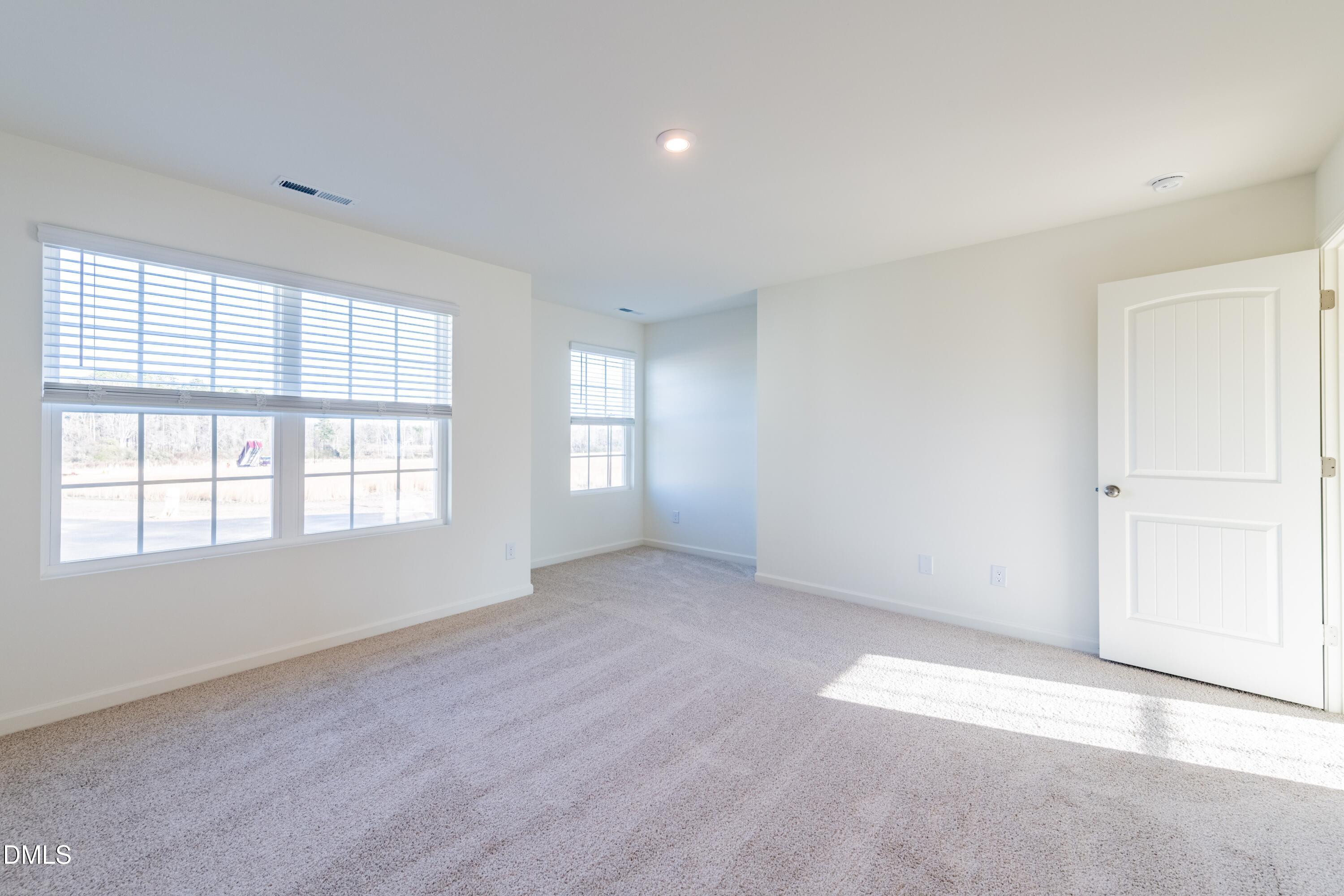 55 Fern Ridge Drive, Unit 1 Cameron, NC 28326 - Photo 21 of 42 an empty room with windows
