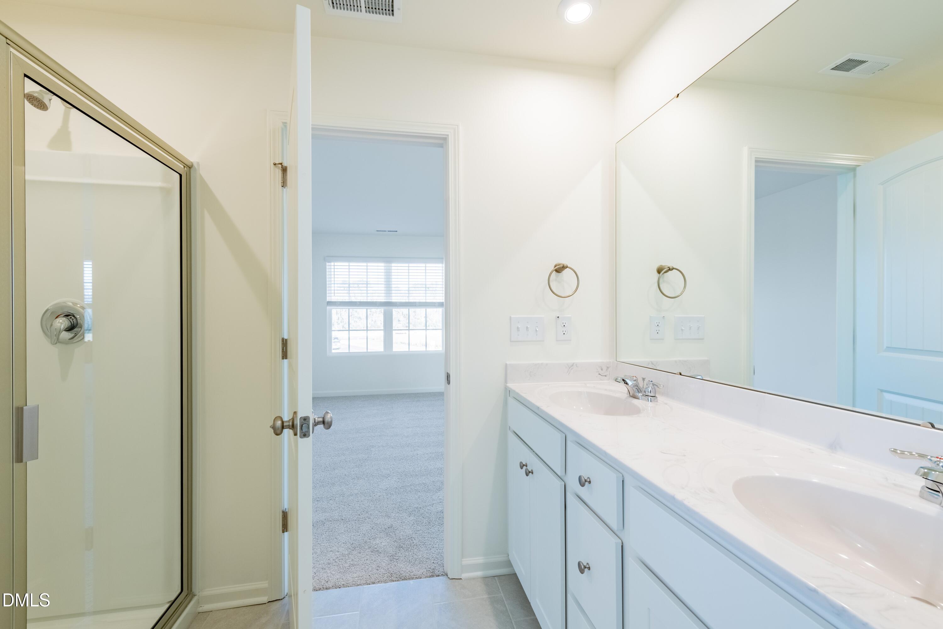 55 Fern Ridge Drive, Unit 1 Cameron, NC 28326 - Photo 22 of 42 a bathroom with a sink and a mirror