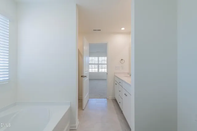 a bathroom with a bathtub and a sink